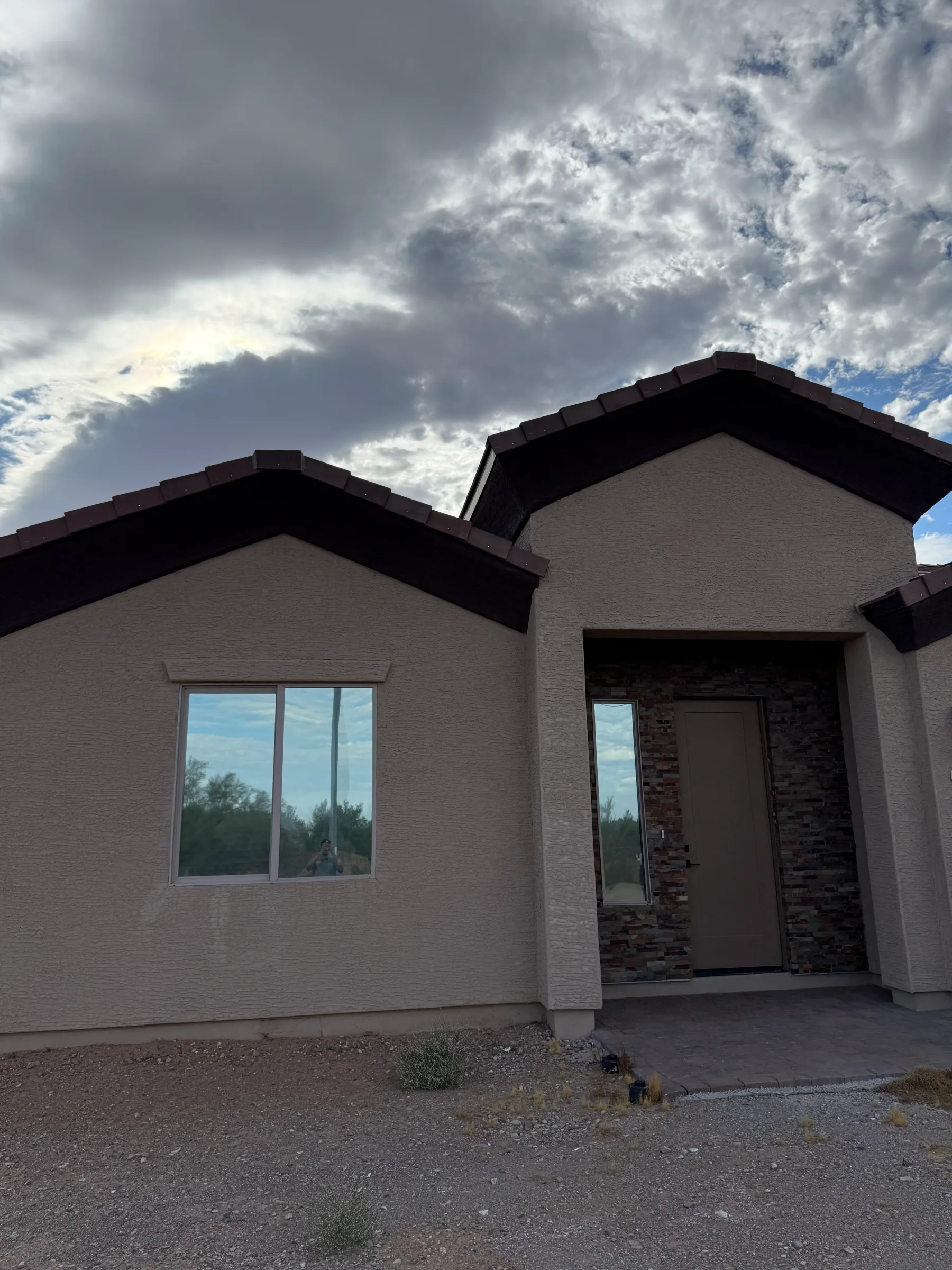 A modern residential home in Cave Creek with large windows and glass doors featuring window tint film applied to reduce glare and heat.