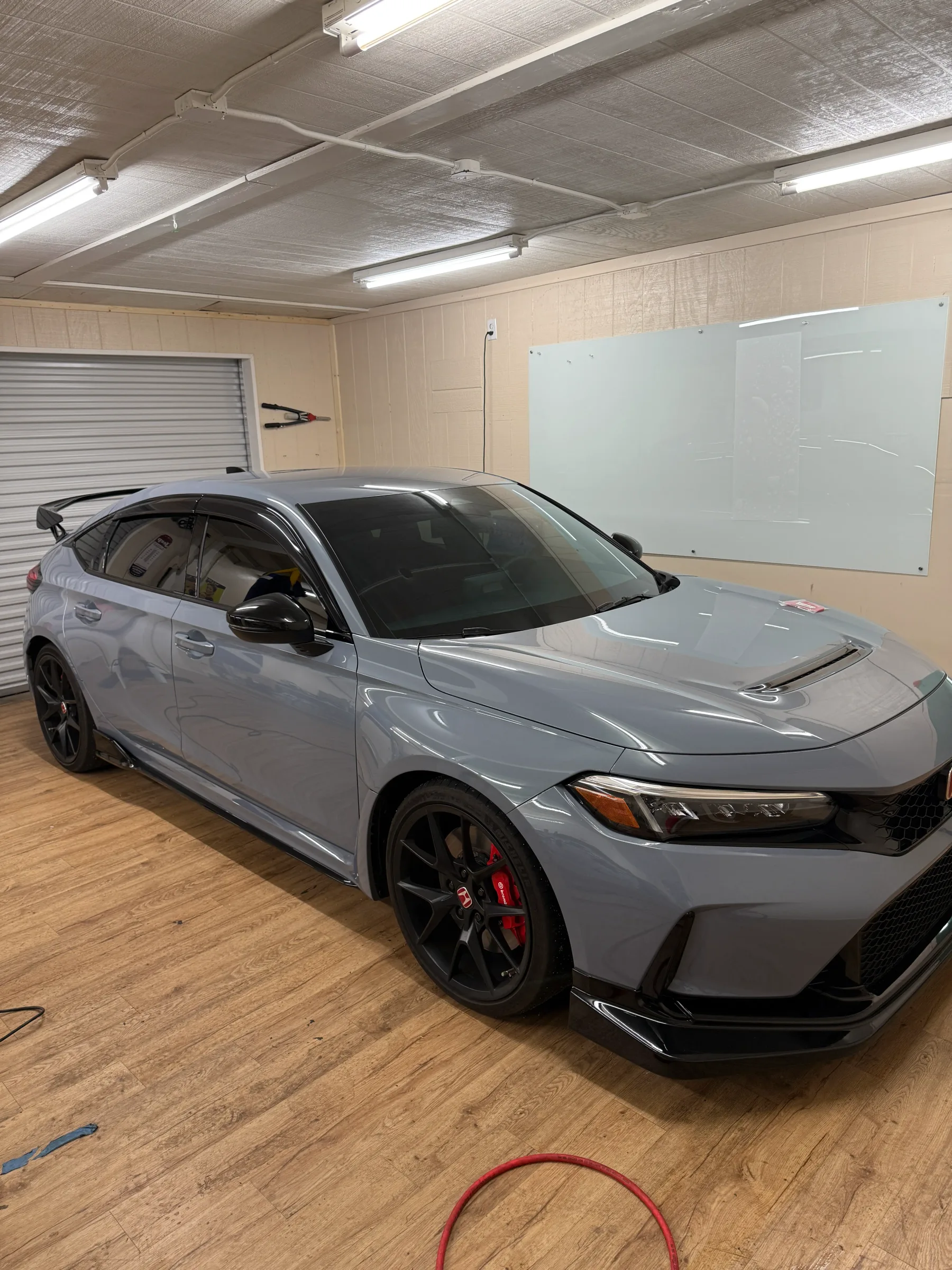 Silver Honda Civic with tinted windows in a professional installation bay at Desert Shade Tinting in Cave Creek, Arizona.
