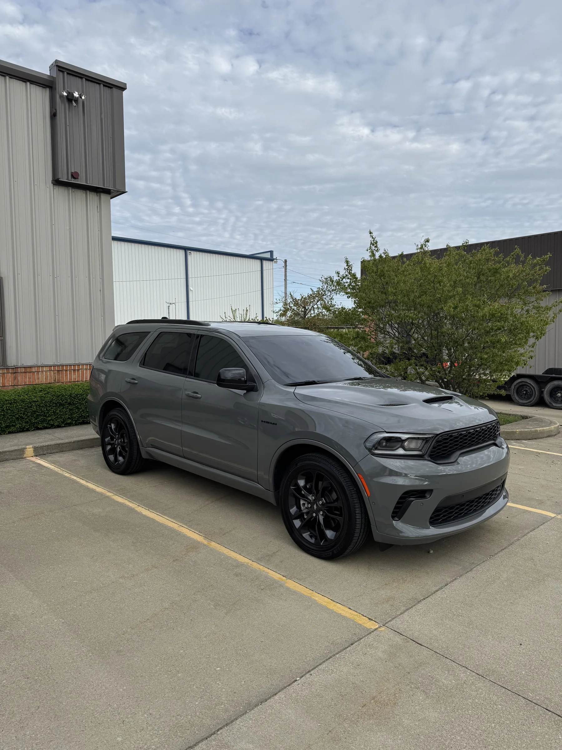 A gray Dodge Durango SUV with dark window tint parked in front of an industrial building in Berea, Ohio.