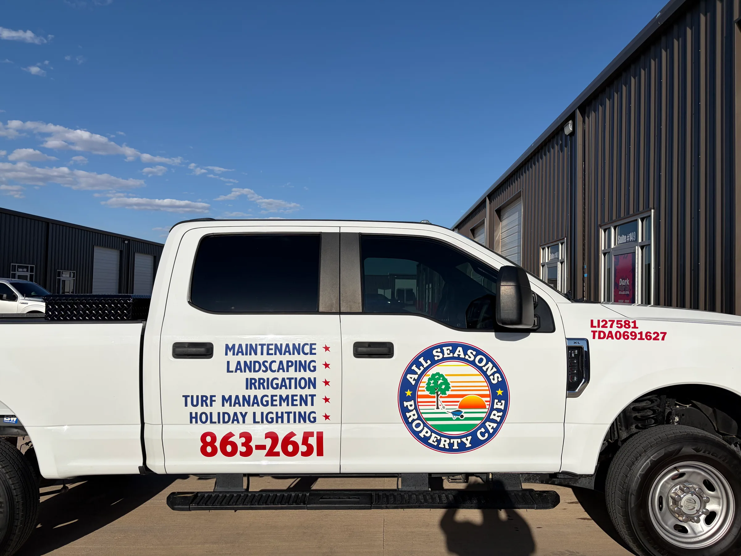White pickup truck with All Seasons Property Care logo and service text displayed on the side doors.
