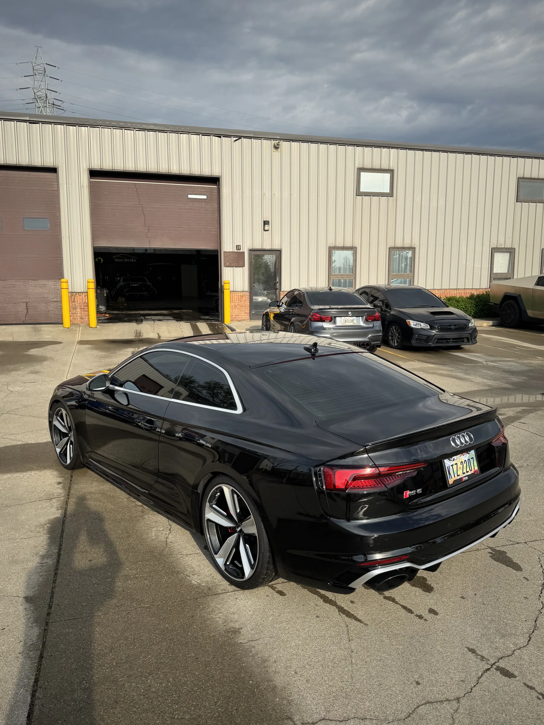 A black Audi S5 coupe parked outside a shop facility in Berea with tinted windows and professional detailing.