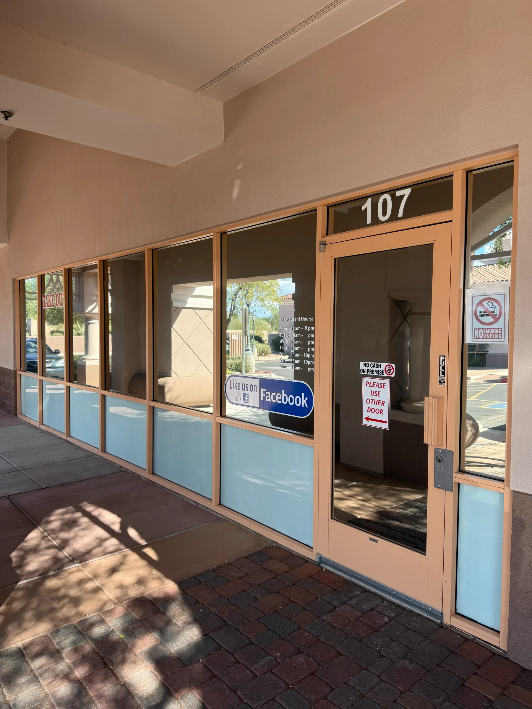 Exterior view of Desert Shade Tinting LLC storefront with window tinting applied to the lower portion of the glass doors and windows at their Cave Creek location.