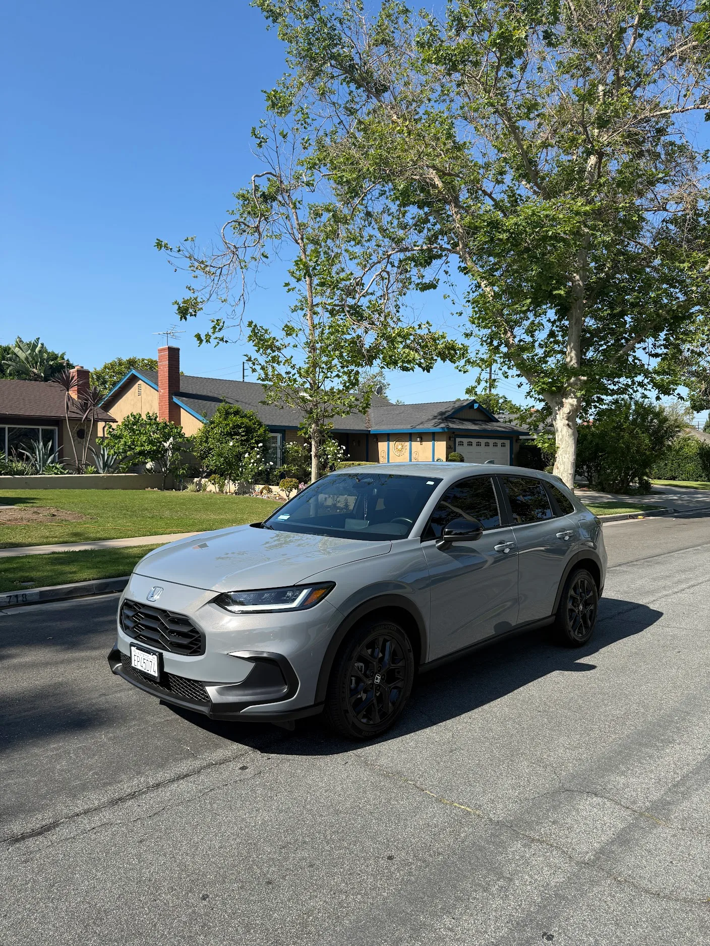 Silver Honda HR-V with tinted windows parked in a residential driveway in Costa Mesa.