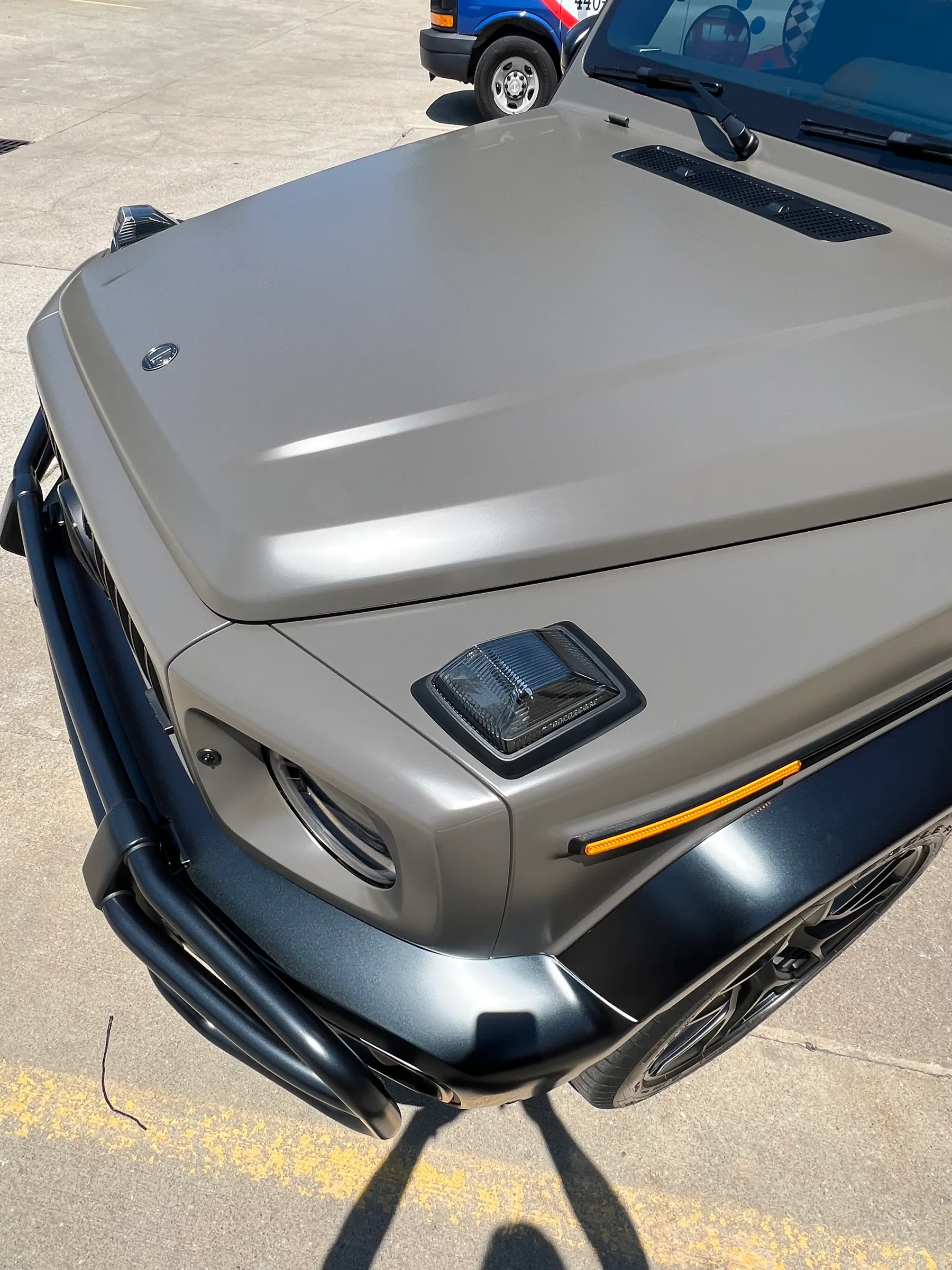 Silver Ford Bronco with clear paint protection film on the hood and black chrome delete accents on the trim and headlight bezels.