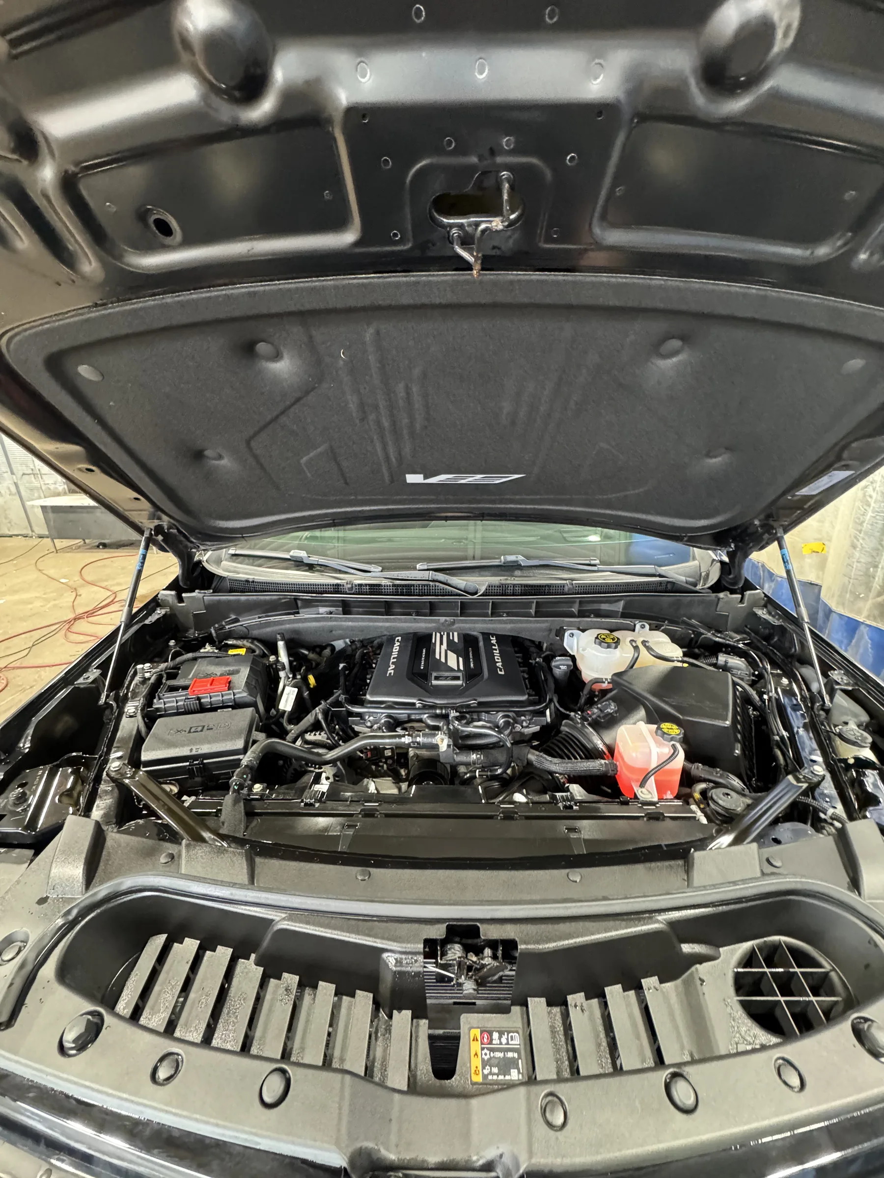 An open hood of a Chevrolet Silverado truck revealing the engine compartment and various components.